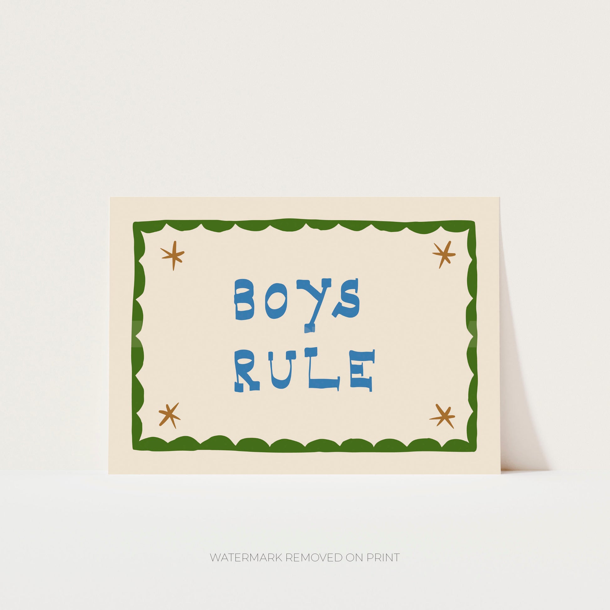 Boys Rule' art print showing blue text on a beige background, with a green decorative border and gold/beige stars in the corner.