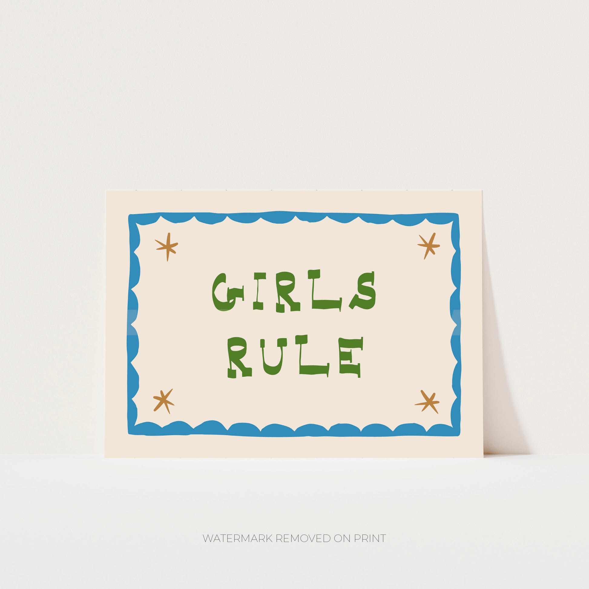 Girls Rule' art print showing green text on a beige background, with a blue decorative border and gold stars in the corner.