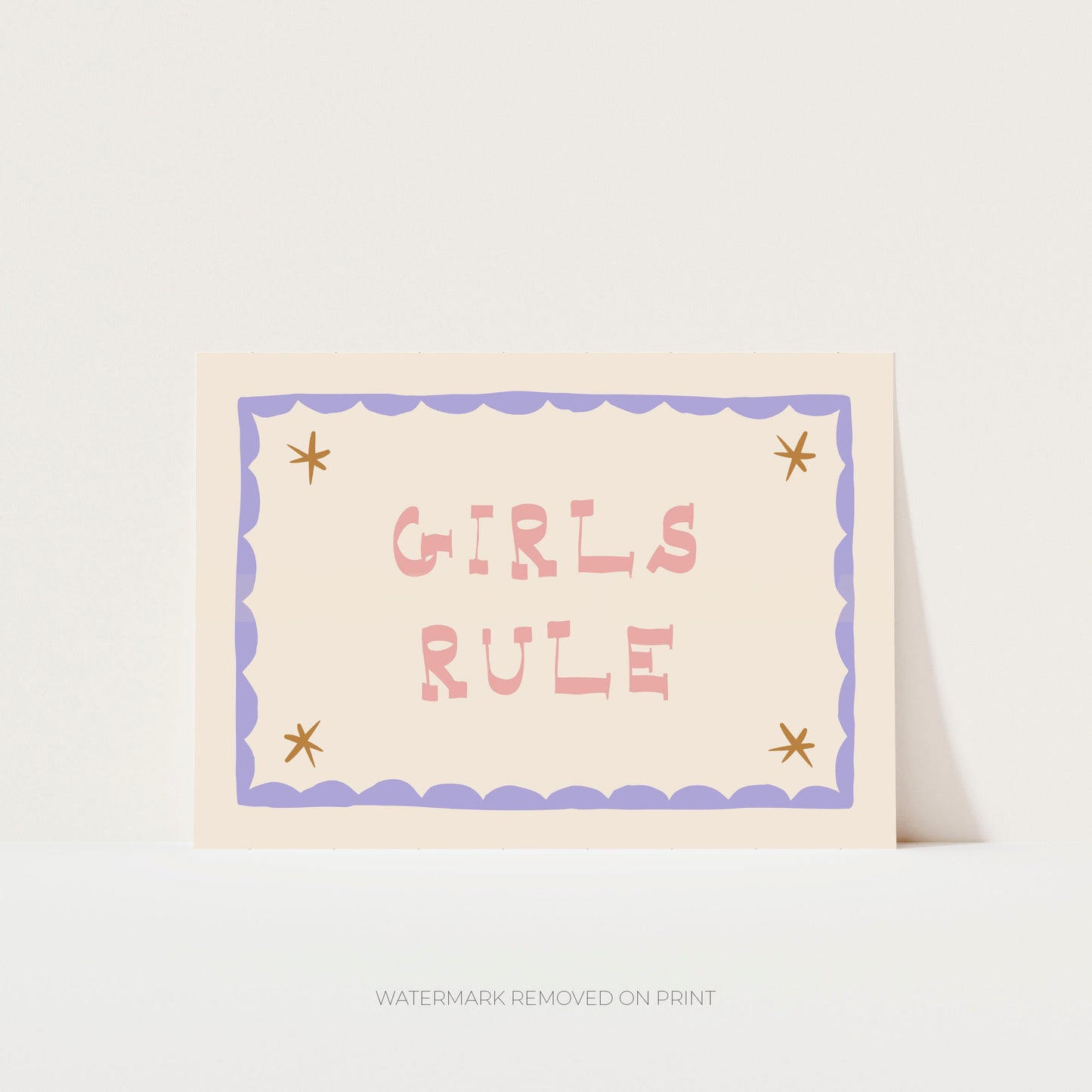 Girls Rule' art print showing pink text on a beige background, with a lilac decorative border and gold stars in the corner.