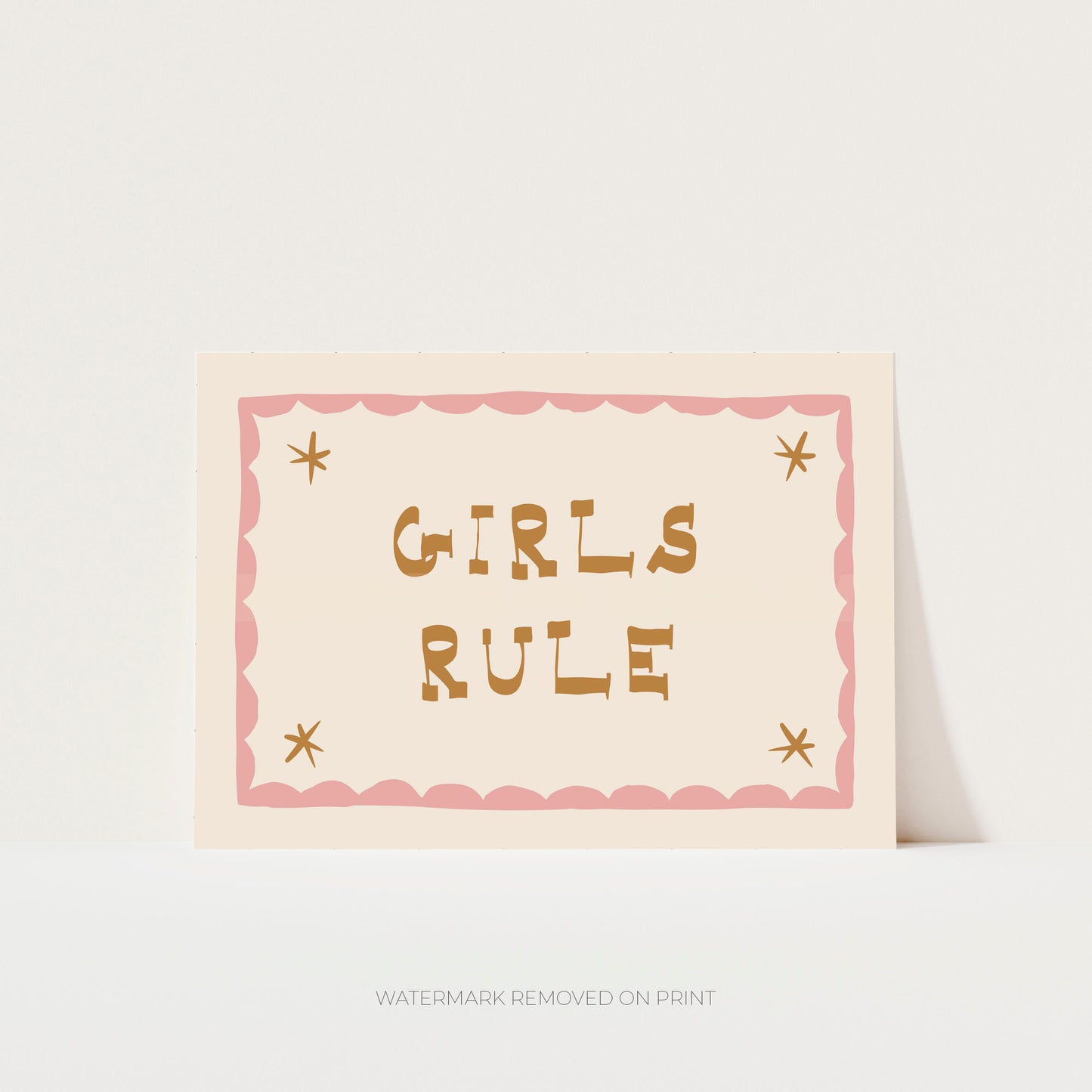 Girls Rule' art print showing the text on a beige background, with a pink decorative border and gold stars in the corner.