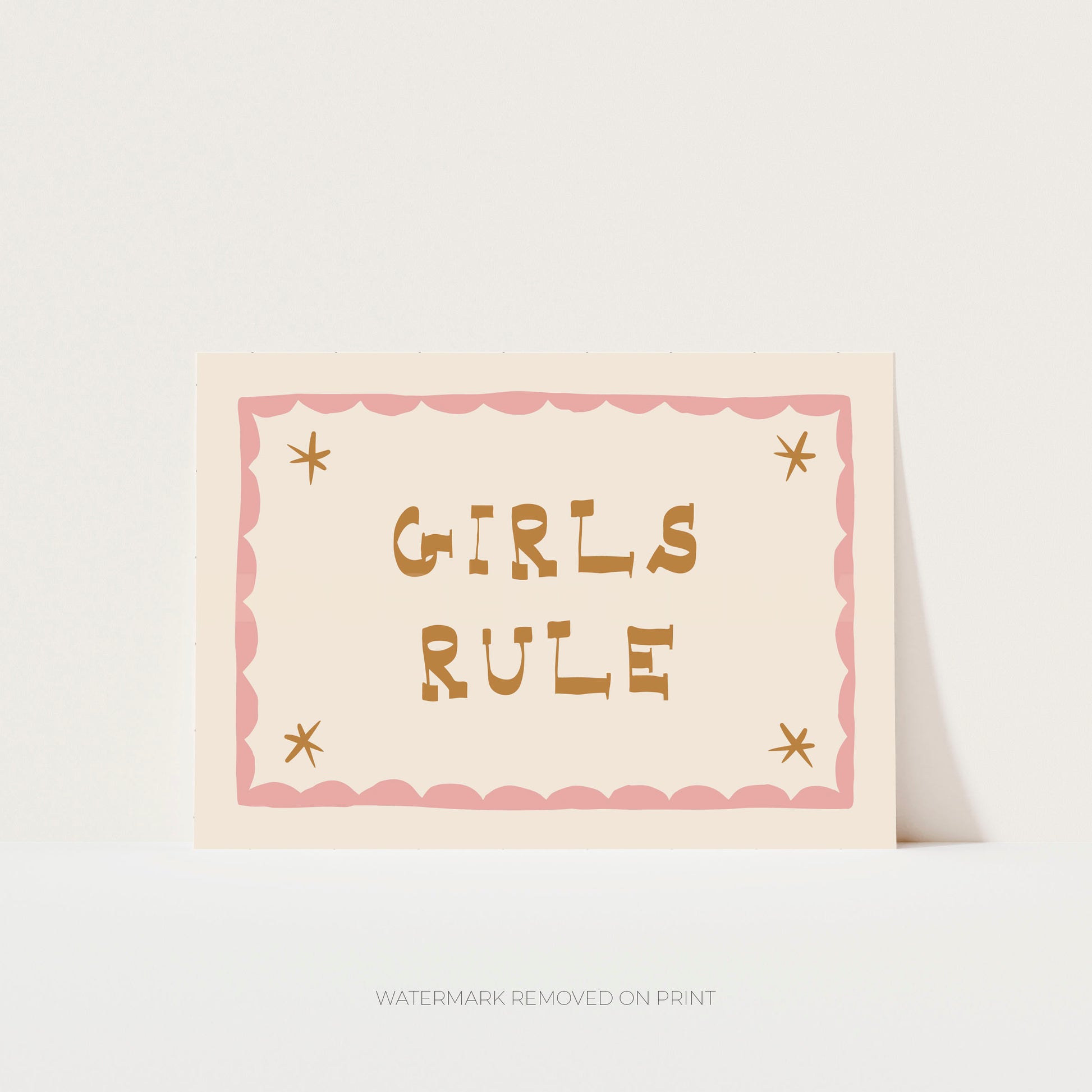 Girls Rule' art print showing the text on a beige background, with a pink decorative border and gold stars in the corner.