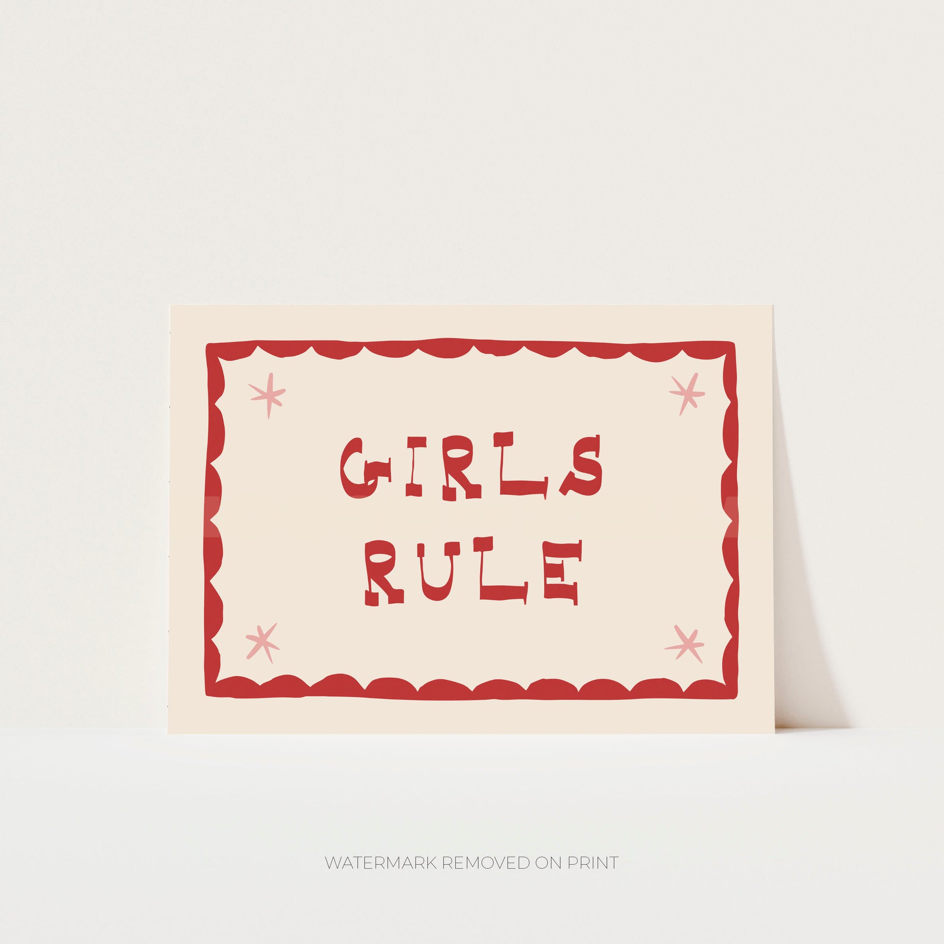 Girls Rule' art print showing red text on a beige background, with a red decorative border and pink stars in the corner.