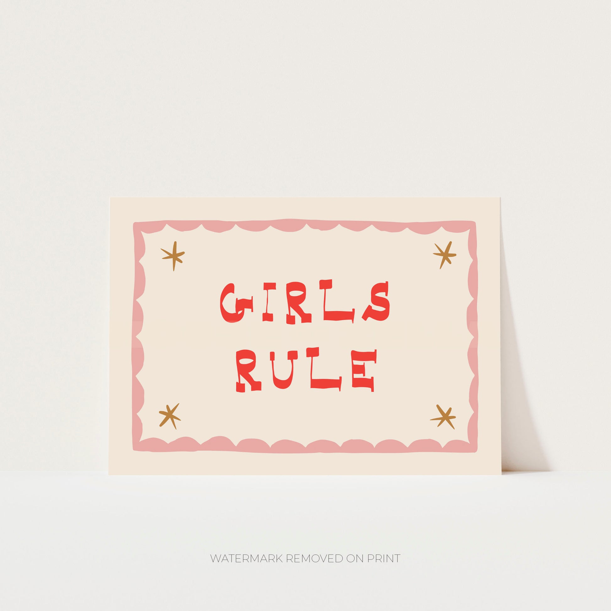 Girls Rule' art print showing red text on a beige background, with a pink decorative border and gold stars in the corner.