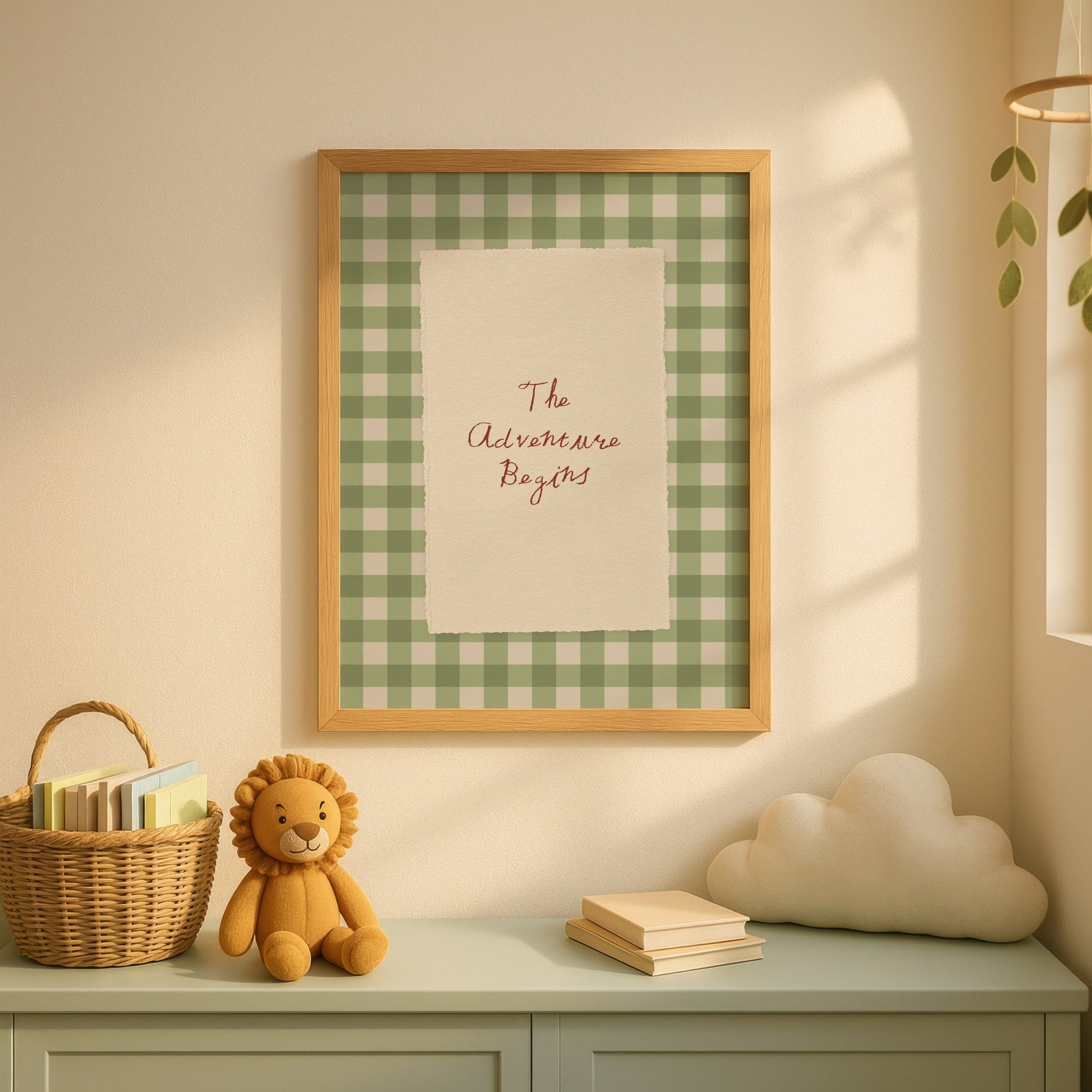 Framed checkered print with text on a wall above a shelf with a teddy bear, books, and a cloud-shaped object.