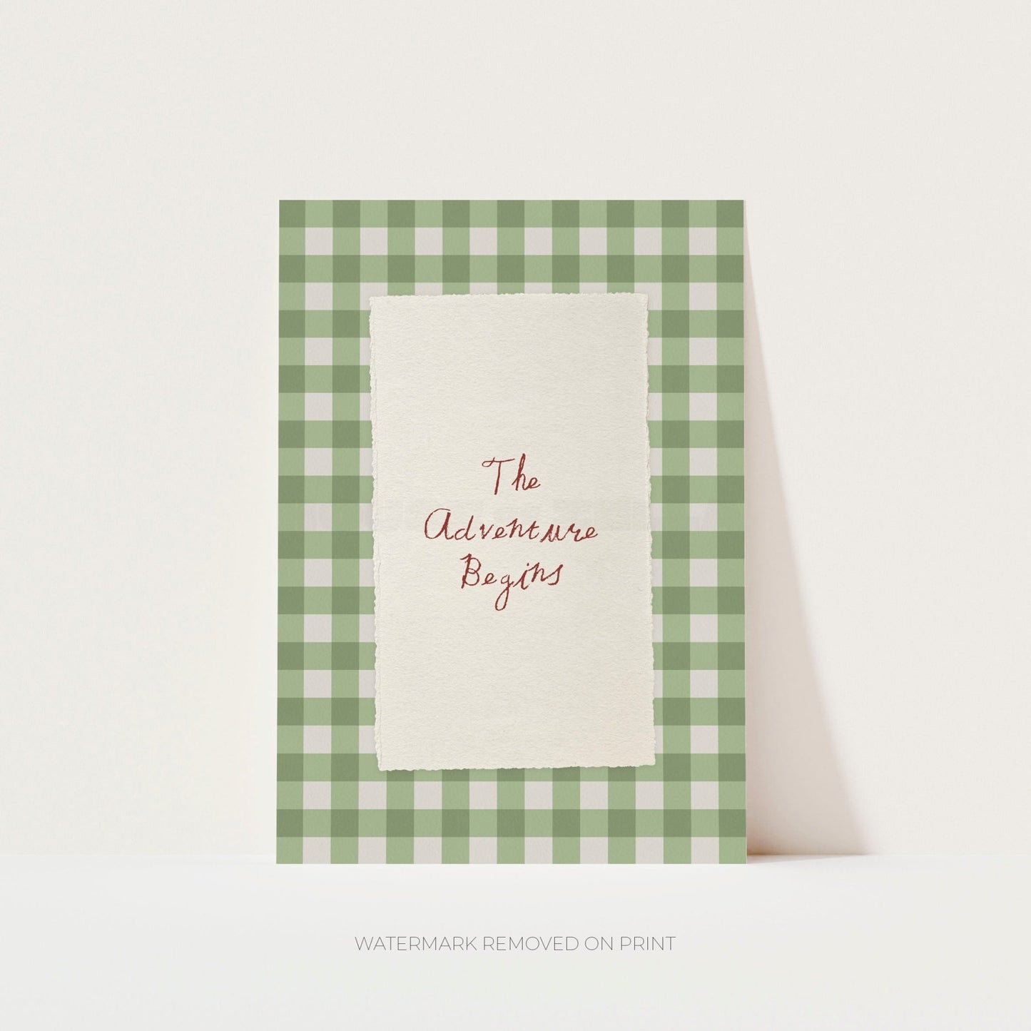 Card with 'The Adventure Begins' text in a green and white checkered frame on a white background