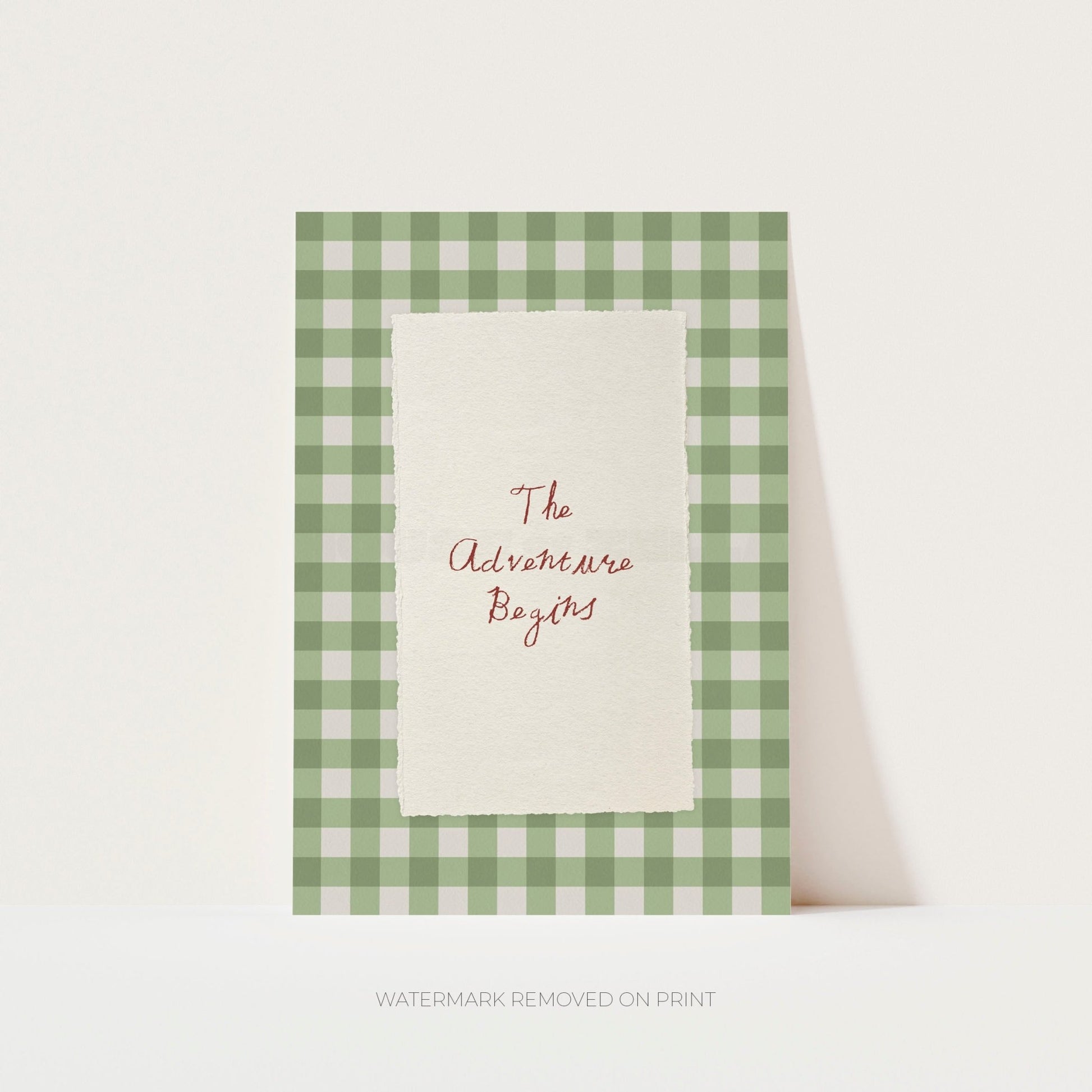 Card with 'The Adventure Begins' text in a green and white checkered frame on a white background