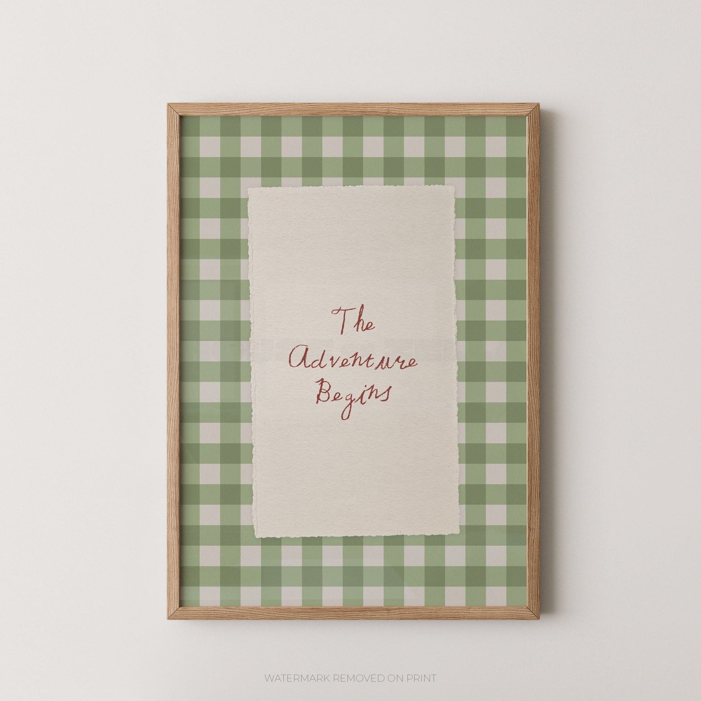 Framed print with 'The Adventure Begins' text on a green and white checkered background