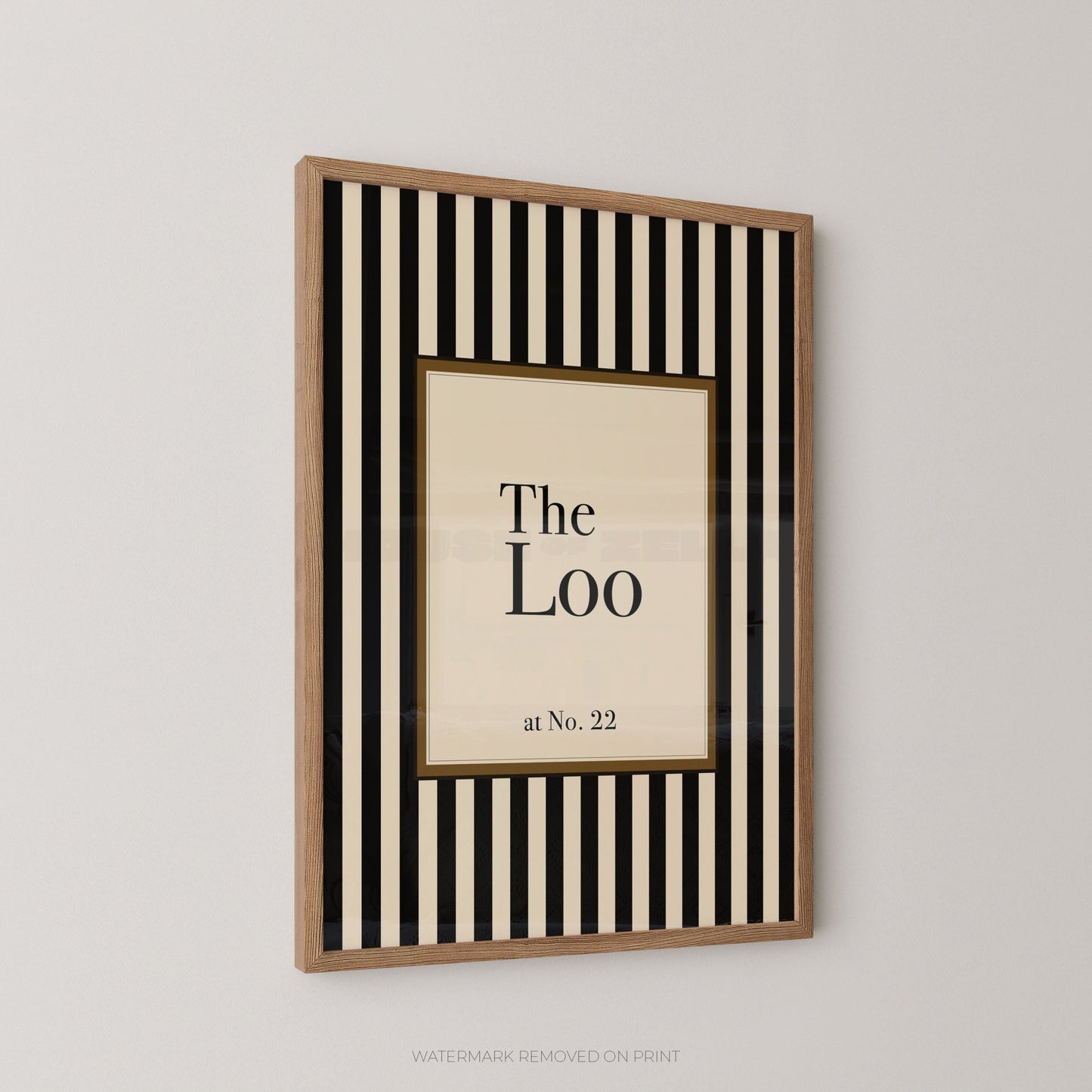 Framed artwork with 'The Loo at No. 22' text on a striped background